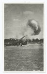 Big gun being discharged, the fire being adjusted from an army balloon.