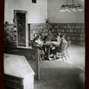 Children reading around table, corner of Circulation department, N.Y.P.L. Children's room, April 1913