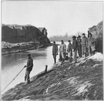 Federal engineers standing along canal.