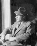 Jed Harris (in hat, seated in armchair, profile)
