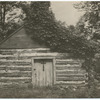 Vine covered log cabin (church?).