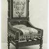 Chair with decorative carving and upholstery.]