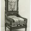 Chair with decorative carving and upholstery.