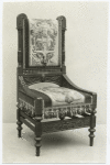 Chair with decorative carving and upholstery.