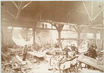 Men in a workshop hammering sheets of copper for the construction of the Statue of Liberty