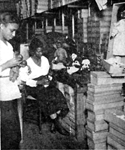 A Negro doll factory in Harlem which provides colored dolls for Negro children