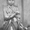 A Kru woman with "shield" finger-rings and hair ornaments