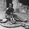 A woman making clay pots