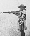 A Gora man firing gun from armpit