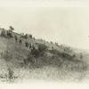 Soldiers walking up a hill