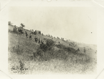 Soldiers walking up a hill