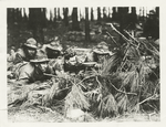 29th Division in training at Camp McClelland, Alabama. Soldiers of 113th Inf. operating a Lewis machine gun concealed by camouflage, 2-19-1918.