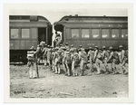Troops in full gear boarding a train