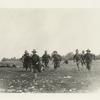 Soldiers running in a field