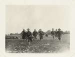 Soldiers running in a field
