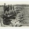 Soldiers aiming rifles from a trench