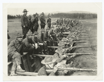 Soldiers aiming rifles from a trench