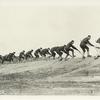 Soldiers charging up a slope with bayonets