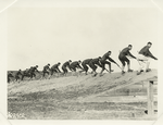 Soldiers charging up a slope with bayonets