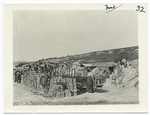 The American advance in the Argonne. Shells and cartridge for American shooting guns being unloaded from a narrow gauge railroad at an ammunition dump behind the American lines in the Argonne. Under cover of night a horse-drawn vehicle which doesn't make as much noise as an engine and isn't so likely to be observed by the Boche, will transport the ammunition to the front.