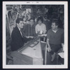 Caffe Cino. Robert Dahdah seated at harpsichord. Ken Burgess at far right in rear, washing dishes in the kitchen and Lee Marvin seated at far right in profile smoking cigarette