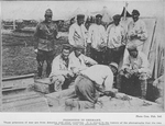 Prisoners in Germany; These prisoners of war are from America and other countries; It is stated in the history of the photographs that the two men shooting crap are American Negroes.
