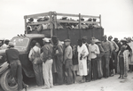 Vegetable pickers, migrants, waiting after work to be paid, near Homestead, Florida, February 1939.