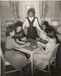 Government hotel for Negro women war workers; A group of young war worker-residents are shown enjoying a game of cards in the fully equipped game room of the Lucy D. Slowe Residence Hall, first government constructed hotels for Negro women war workers in Washington, D.C., between Fall 1942 and April 1943