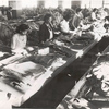 Jersey City Quartermaster Repair Sub-Depot; Negro women play an important part in the conservation activities of the Quartermaster Corps.; Overcoats, shirts, trousers, and other items are prepared for final repair operations by ripping off torn pocket flaps, sleeves, and other portions of garments and replacing with patches or new portions; This is termed 'preparation"; Approximately 100 employees are engaged in preparing clothing similar to view shown in photograph
