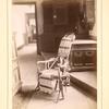 Stand featuring an interior bookcase, armchair, and pictures