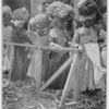 At the fruit-shipping ports on the north coast of Jamaica hundreds of thousands of bunches of bananas are transferred from train to steamer on the heads of an endless procession of turbaned Negro women.