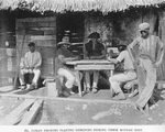 Cuban Negroes playing dominoes during their midday rest.