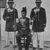 The "Granman" or Chief, Osesi, of the Aukan tribe of Bush Negroes; Accompanied by his two ministers or "adjutanten," Dutch Guiana.