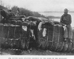 Cotton bales awaiting shipment on the banks of the Mississippi.