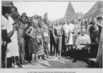 A Gio King [sitting] with his musicians and dancers.
