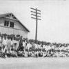 A group of colored children in front of a portable school building in a northern city.