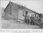 Mammy Veenie, in her cabin home, near "Mirador," surrounded by her "chilluns an' her gran'chilluns."
