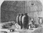 Female in hut polishing clay