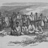 Group of people some in background with horses and four sitting on the ground