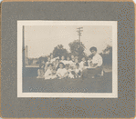 Highbridge, Exterior, librarian and children on grass looking at camera