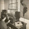 A blind man adjusts the volume on a "talking book" at the New York Public Library's Library for the Blind