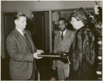 Schomburg Collection Mrs. Roosevelt presenting the President's manuscript copy of the radio address on the Atlantic Charter: Mr. Francis R. St. John, Chief of Circulation Department, New York Public Library; Dr. Lawrence D. Reddick, Curator of the Schomburg Collection of Negro Literature; Mrs. Franklin D. Roosevelt