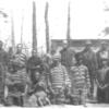 A group of negro prisoners showing stripes and chains.