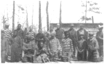 A group of negro prisoners showing stripes and chains.