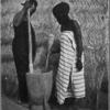 Women pounding corn.