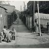 Children playing in the Defrees Alley, NE Washington, D.C.; Near Capitol Building; One basement room rents for $9.00 a month, two rooms upstairs for $ 16.00, one bath and cold water in the hall for entire building.