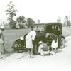 Repairing tire on road near Knowlton Plantation, Perthshire, Mississippi Delta, Mississippi, October 1939.