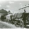 Part of cotton gin with wagonloads of cotton waiting in background at Delta and Pineland Company, Scott, Mississippi Delta, Mississippi, October 1939.