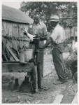 An FSA [Farm Security Administration] supervisor consults a borrower about unsanitary water supply; Safe well demonstration, near La Plata, Maryland [Charles County,] July 1941.