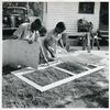 Applying the screen on the inside face of door; Demonstration of home screen door construction; Saint Mary's County, Ridge, Maryland, July 1941.